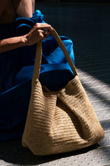 Seated woman with TIFFANY bag